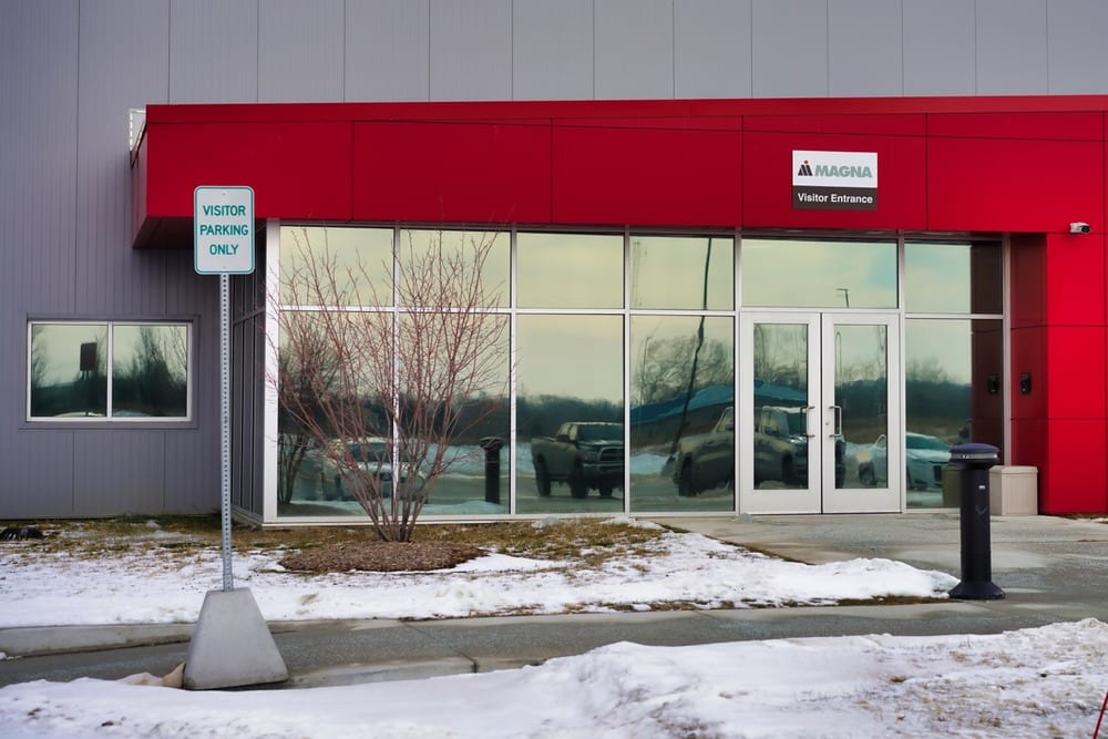 Commercial building with reflective window film mirroring the parking lot