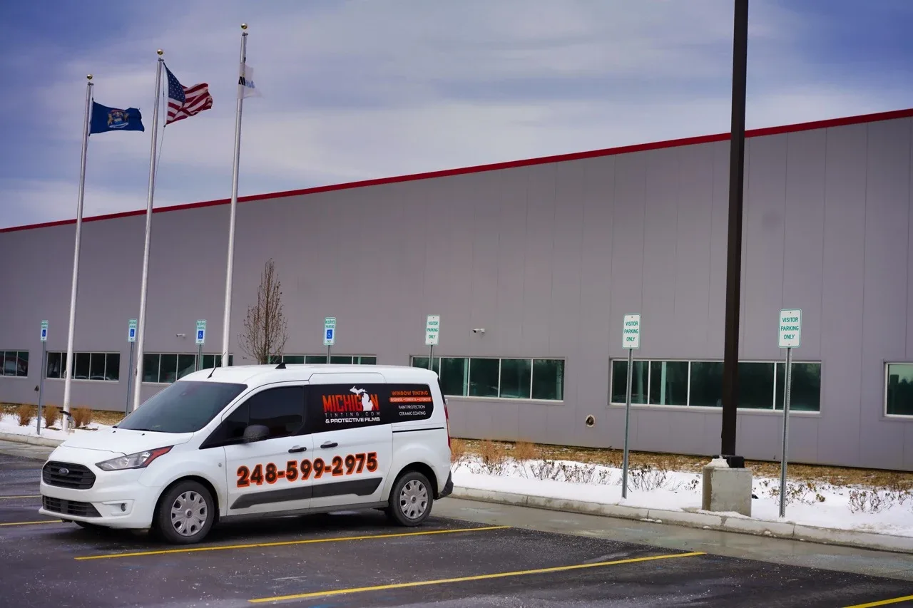 Commercial building with tinted glass and the company van