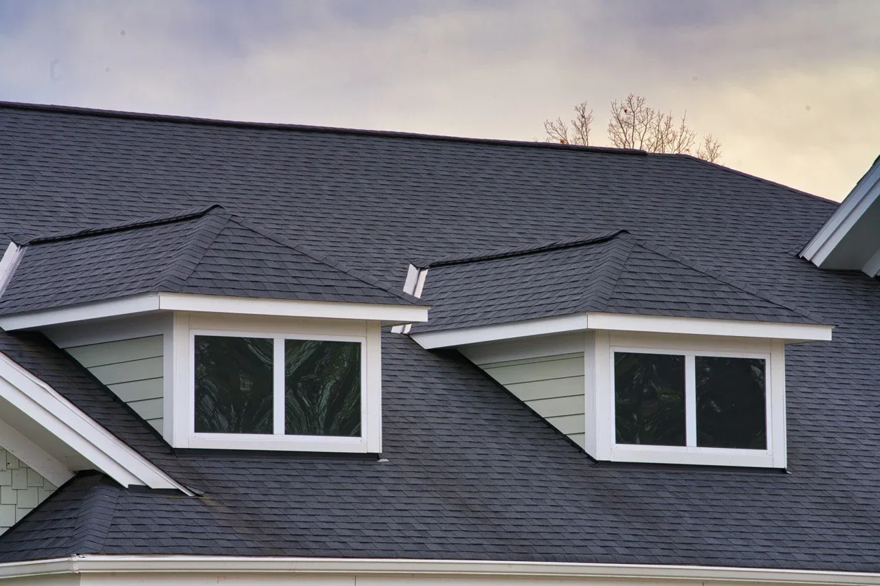 Dormer windows with dark heat-control film